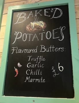Potatoes from the farm, baked to perfection and stuffed with the flavoured artisan butter of your choice